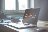 A serene workspace featuring a laptop with digital time display, perfect for productivity and focus.